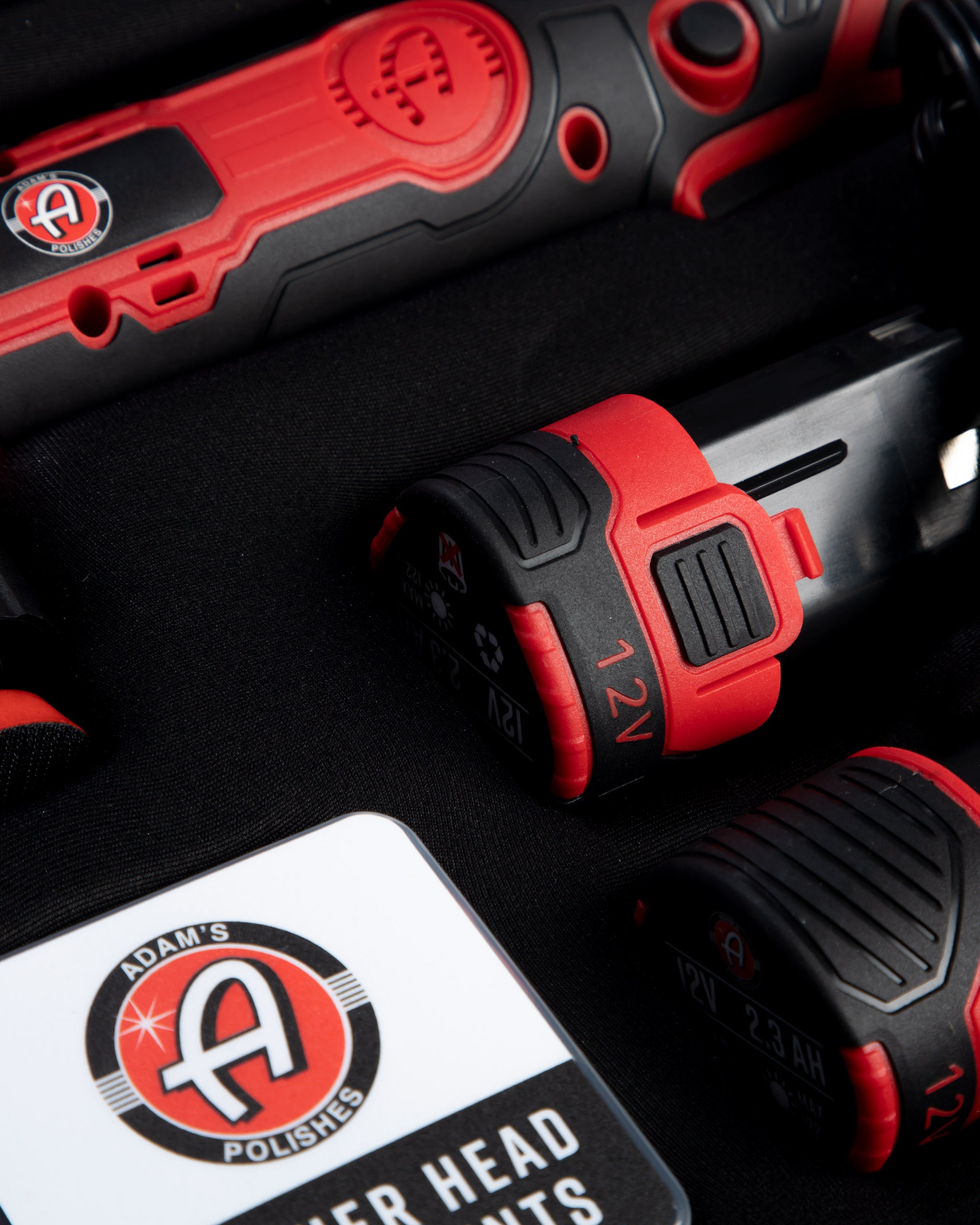 Alt text: Close-up view of Adam’s SK Pro Micro Polisher 2.0 Mystery Box, featuring a red and black tool with detailed branding and battery labels, priced at $229.99.