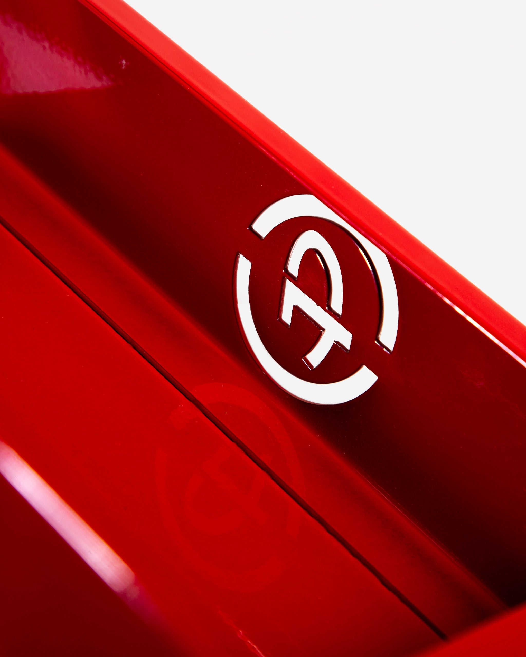Close-up image of a red Adam's 1 Gallon Holder featuring a prominent embossed logo on its side.