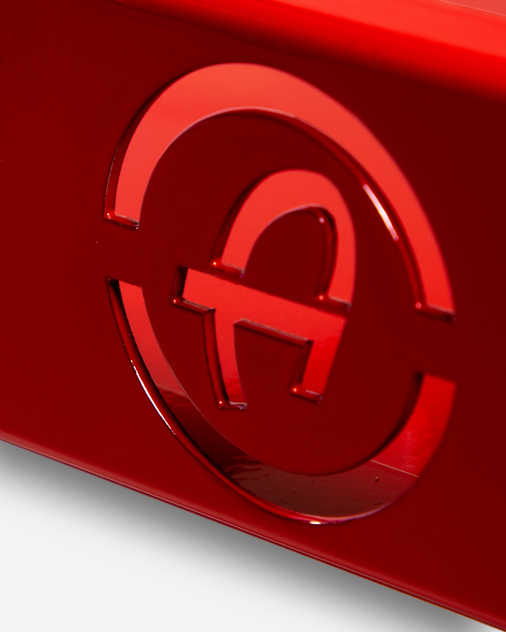 Close-up view of a shiny red Adam's 1 Gallon Holder featuring the embossed Adam's logo.