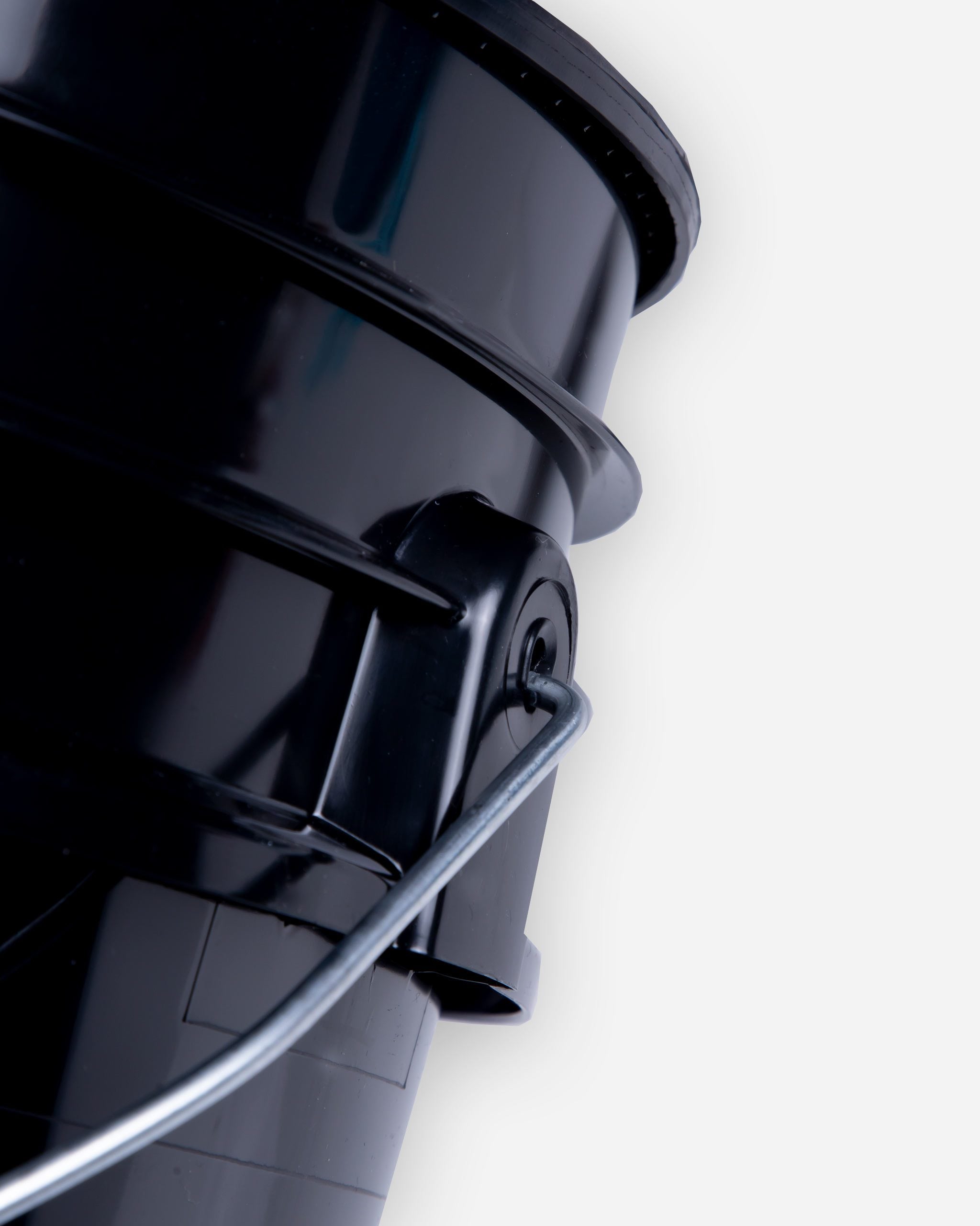 Close-up of a black, stackable Adam's mystery bucket with a silver handle, priced at $69.99, showing the edge and handle attachment details.