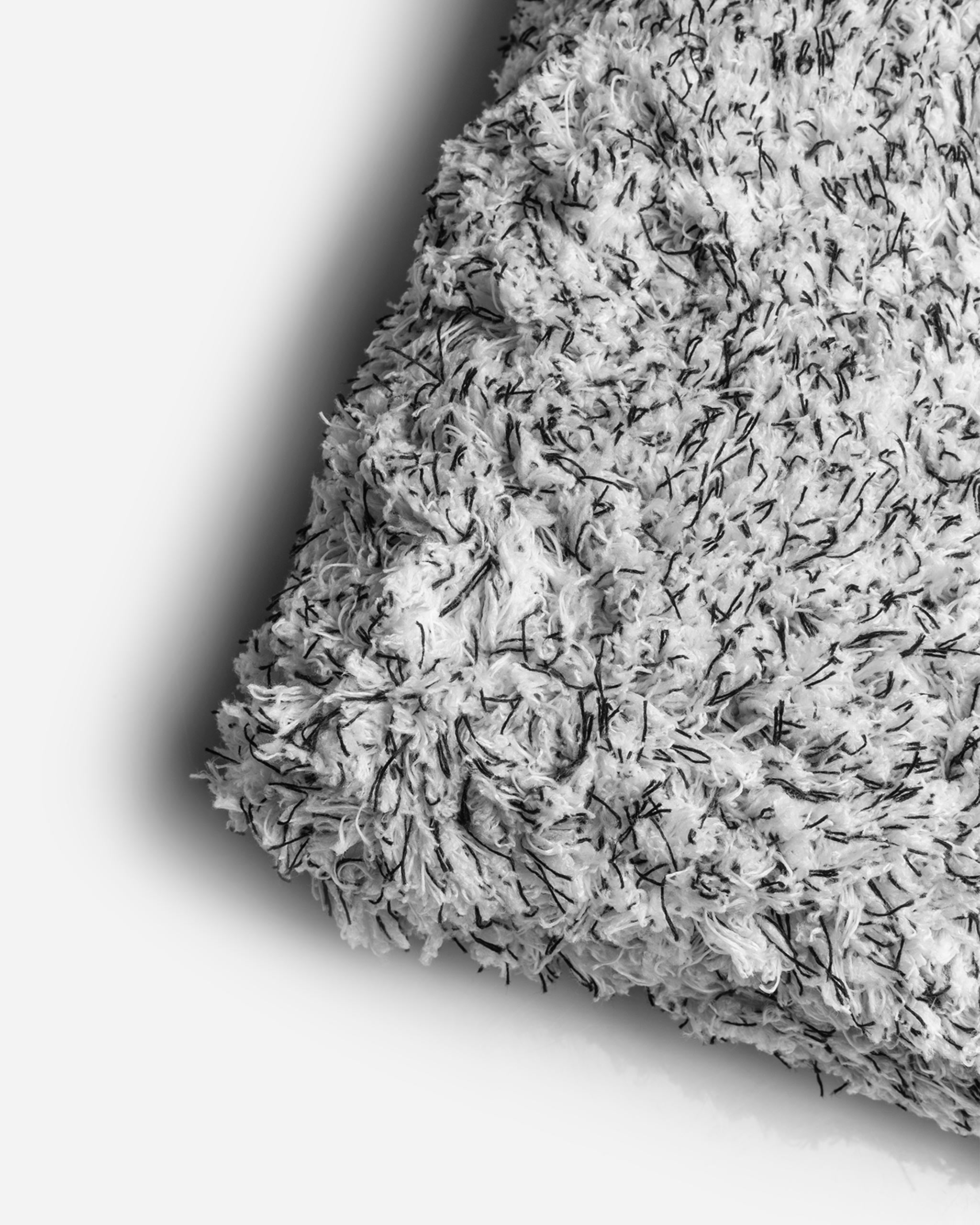 Close-up of Adam's 10-inch Microfiber Wash Sponge showing the textured surface with dense white and black fibers ideal for car washing.