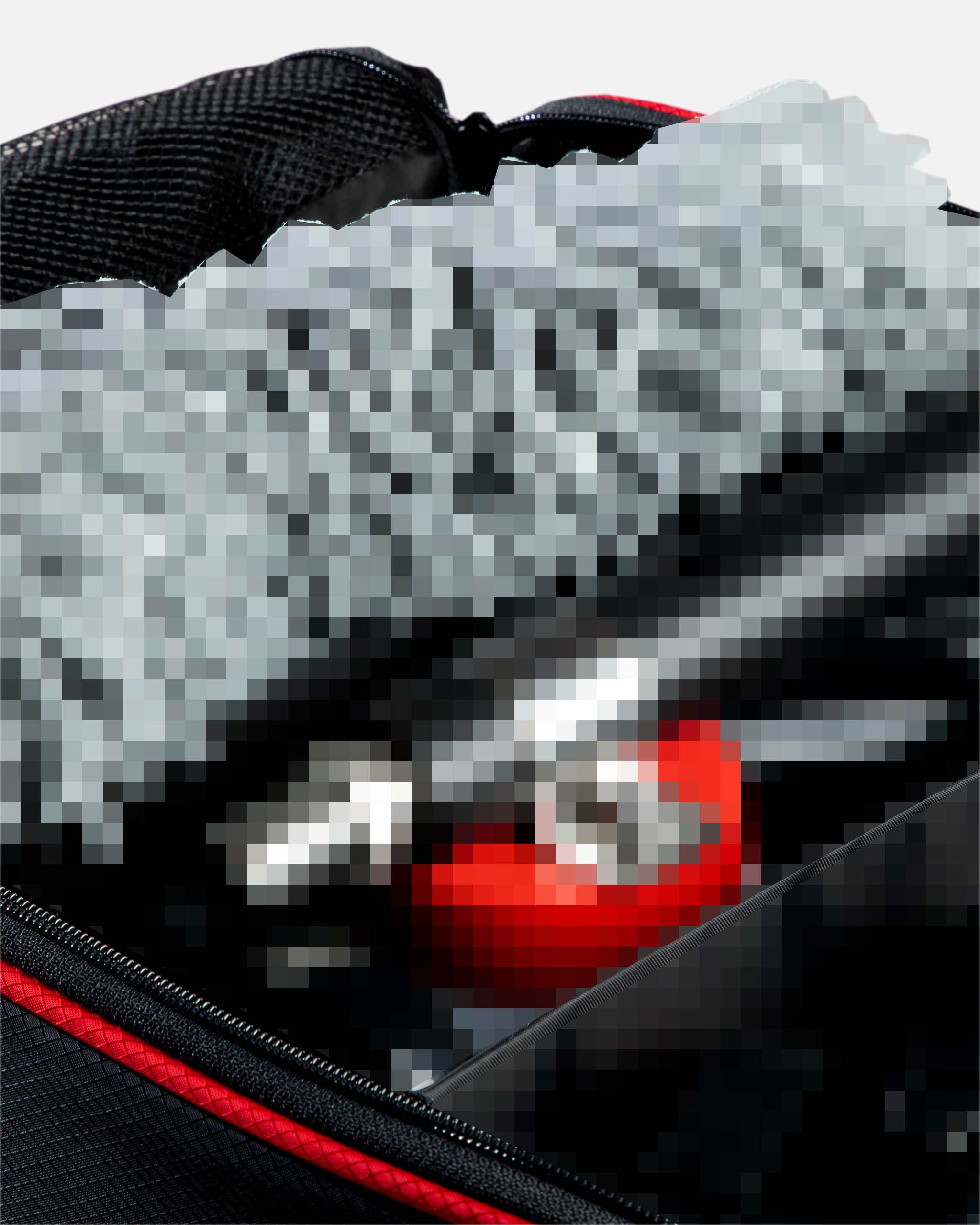 Alt text: Close-up of a black and red Adam's Random Mystery Trunk Organizer V2, partially obscured by digital pixelation, hinting at the mystery contents inside.