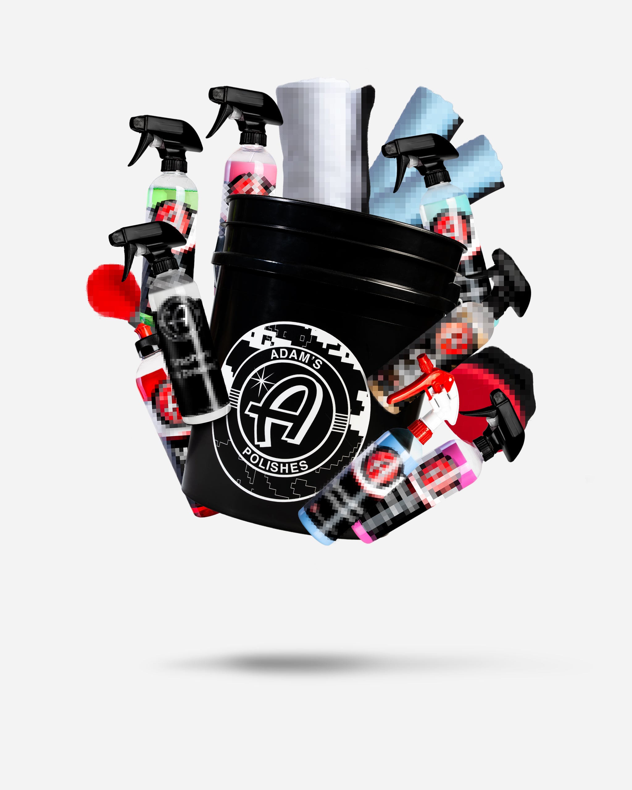 Alt text: "Adam's $69.99 Mystery Bucket filled with various car care products including spray bottles, microfiber towels, and sponges, partially visible and arranged in a black bucket with the Adam's Polishes logo on it."