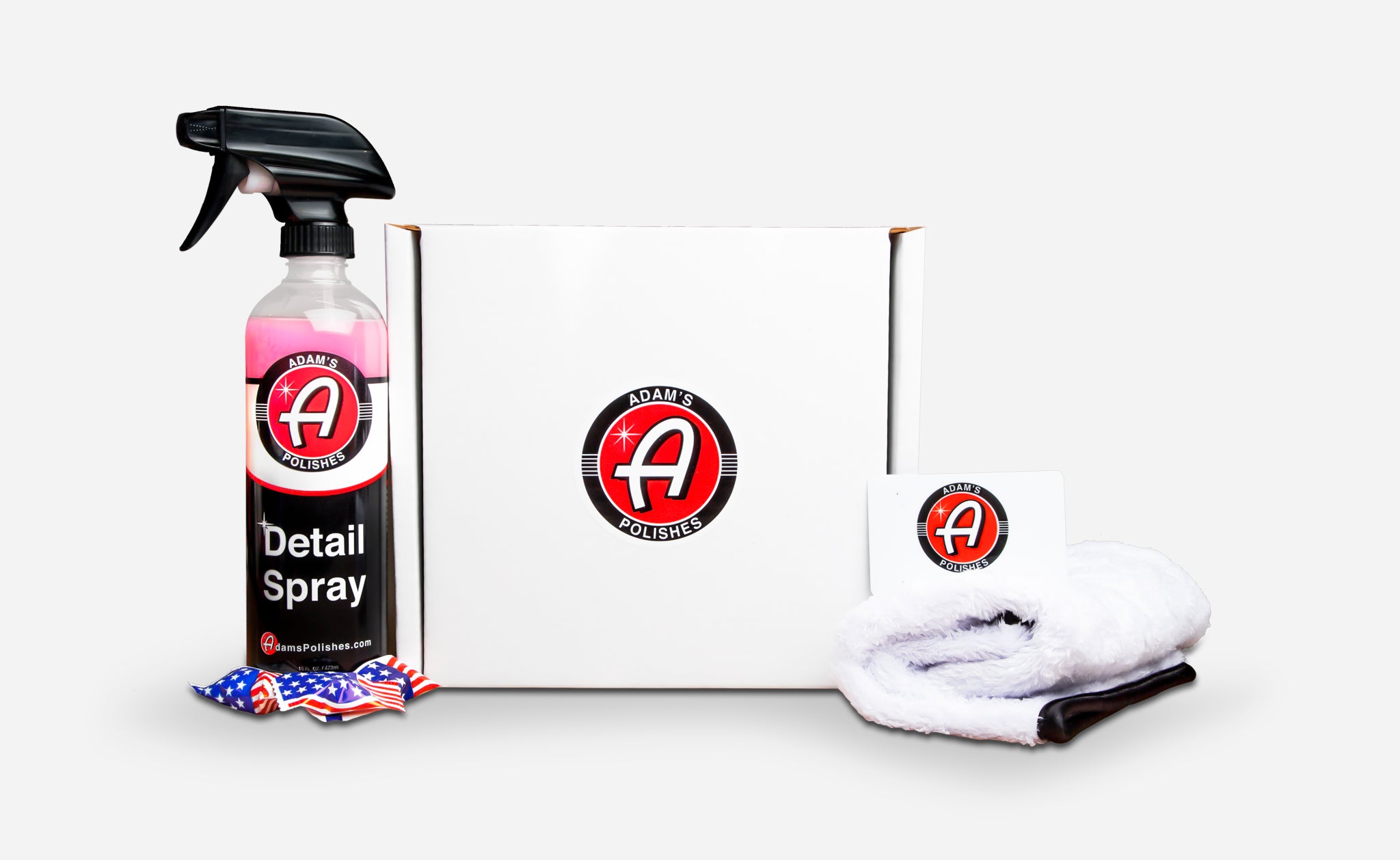 Adam's Polishes product set featuring a bottle of Detail Spray, a white gift box with logo, a $50 gift card, and a plush microfiber towel on a white background.