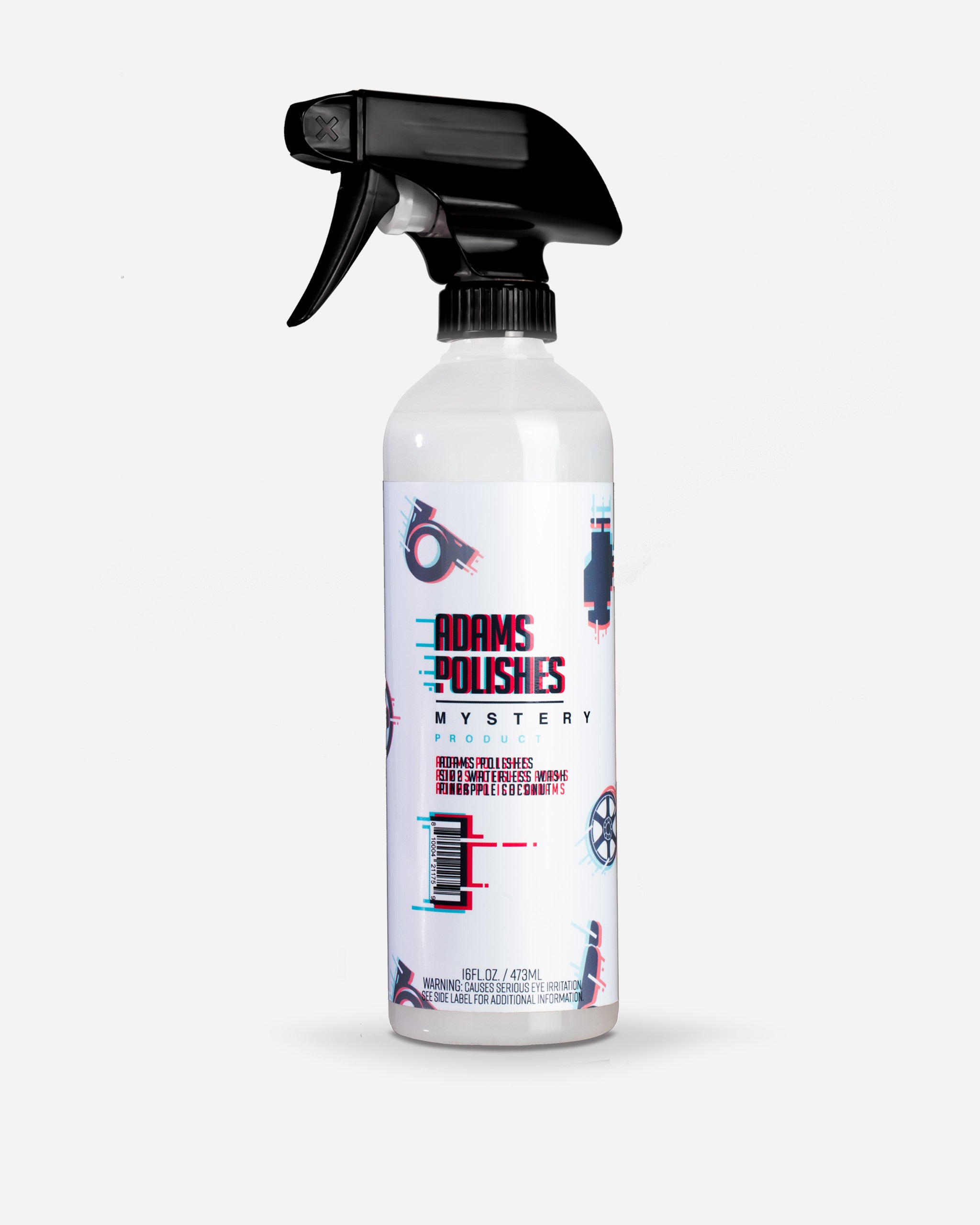 Alt text: "A bottle of Adam's $5 Mystery Chemical with a spray nozzle on top. The white bottle features bold red and blue graphics with text stating 'Adams Polishes Mystery Product'. It is marked as a 16 fluid ounce container