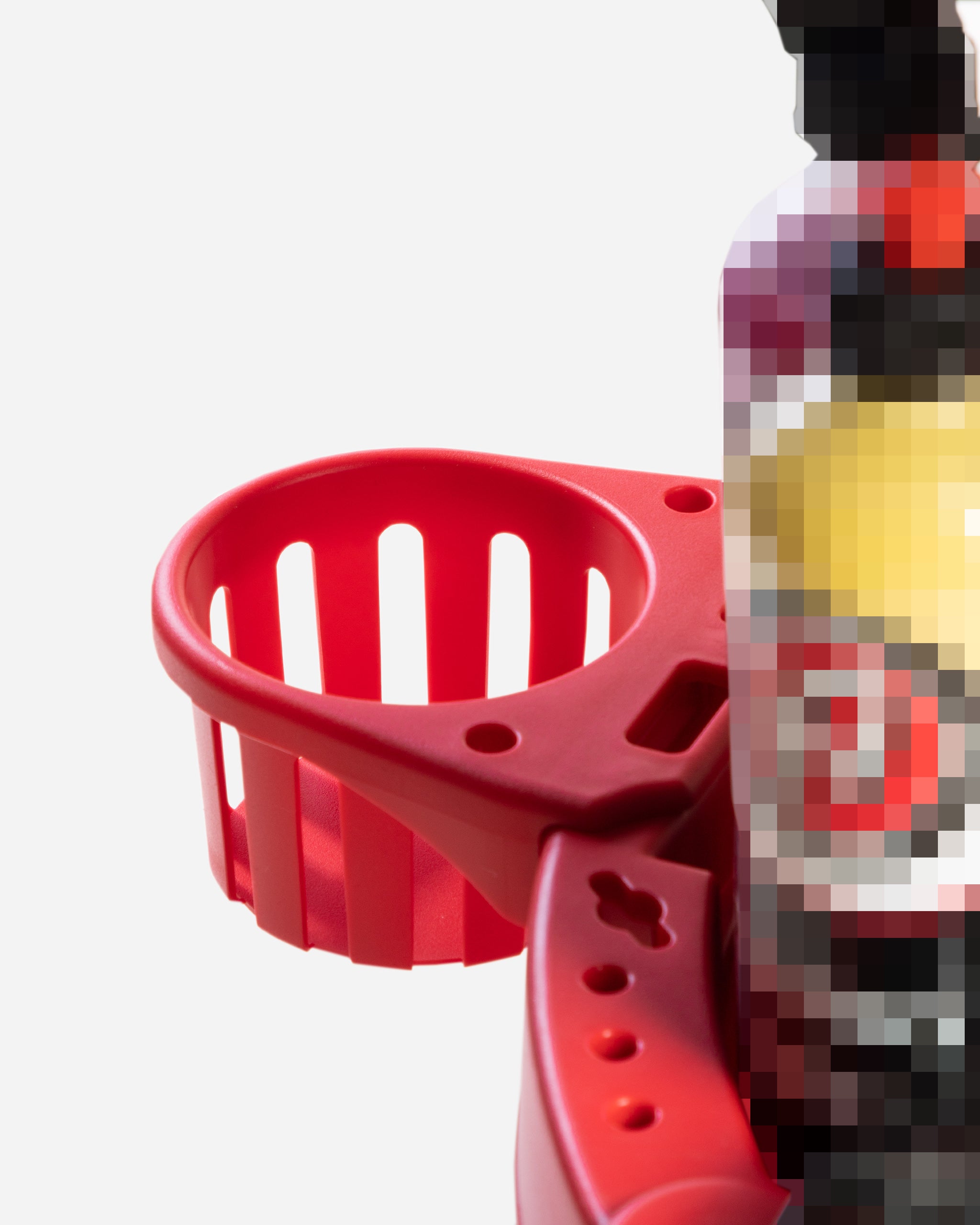 "Close-up view of a section of Adam's Mystery Detailing Stool, featuring a red plastic holder with slots for tools and supplies, partially visible next to blurred bottles of cleaning or detailing solutions."