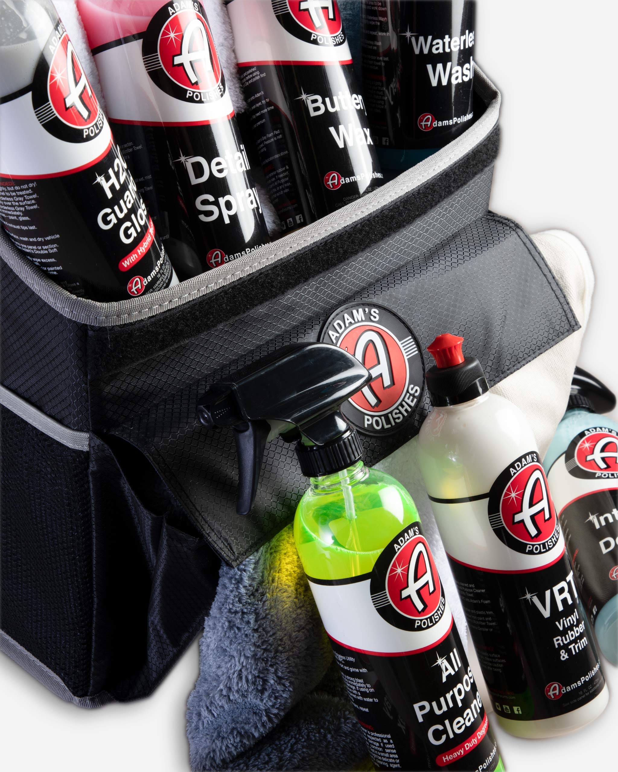 Alt text: Close-up of Adam's $99.99 Mystery Trunk Organizer featuring an assortment of Adam's Polishes car care products including cleaners, waxes, and towels, all neatly arranged in a black, durable trunk organizer.