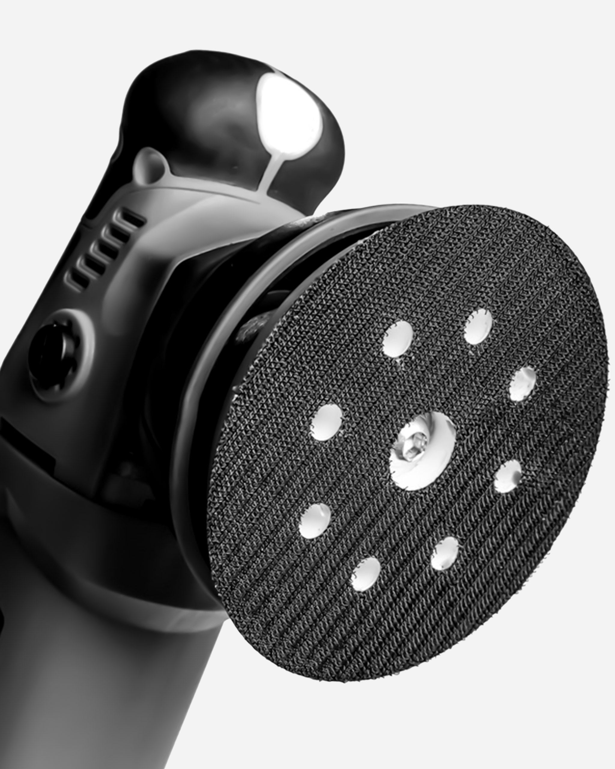Alt text: Close-up view of the Adam's SK Pro 15mm Polisher, featuring a black and chrome body with an attached polishing pad, highlighted by its precision engineering and durable design.